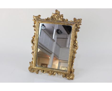 A small gilt wood and gesso rectangular wall mirror with scroll carved frame, mirror plate 22cm by 16cm