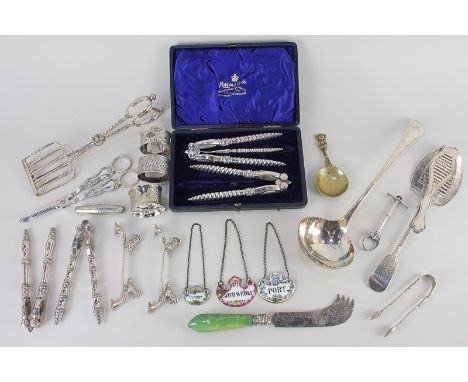 A collection of plated tableware and other items, to include a ladle, three napkin rings, grape scissors, sugar nips, two ser