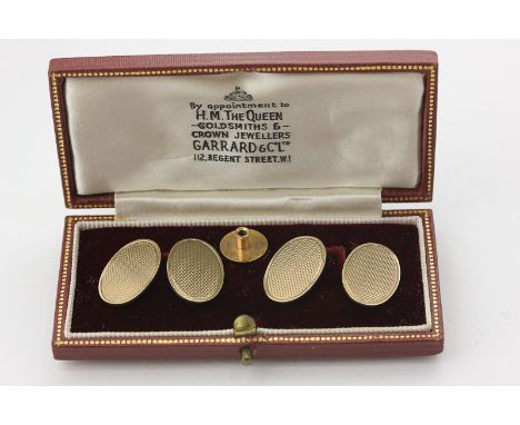 A pair of 9ct gold cufflinks, engine turned ovals, 7.9g, a gold stud base