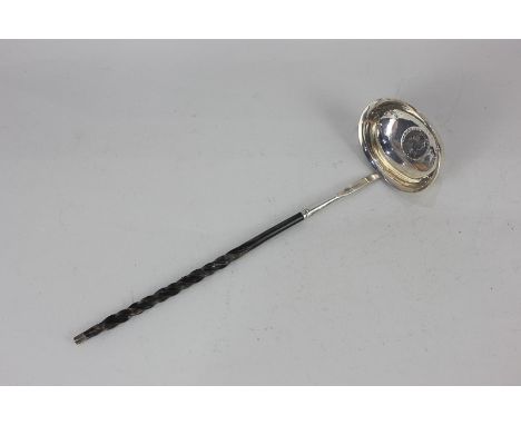 A George III silver punch ladle with 1787 coin inset and whalebone handle, maker's mark worn, London 1799, 30cm long