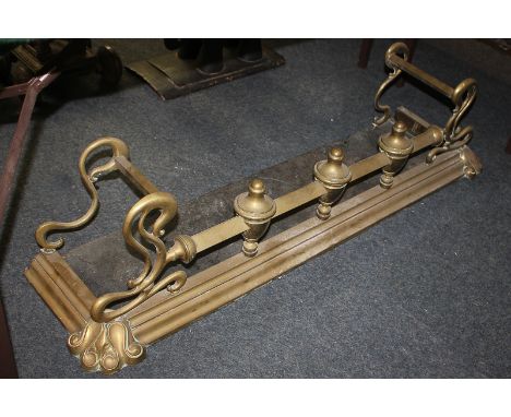 A brass fire fender with rail on finial supports, 123cm