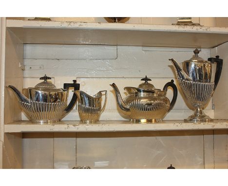 An Elkington silver plated oval teapot, another similar with cream jug by Goldsmiths &amp; Silversmiths Co, and a demi fluted