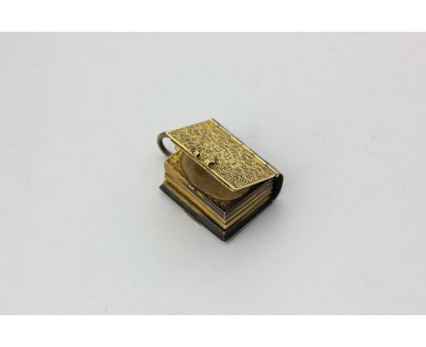 A Victorian gold locket in the form of a book with five portrait pages