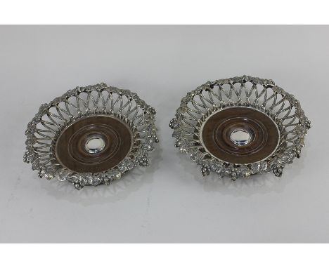 A pair of Elkington &amp; Co silver plated wine coasters with lattice border and applied decoration of fruiting vines to the 