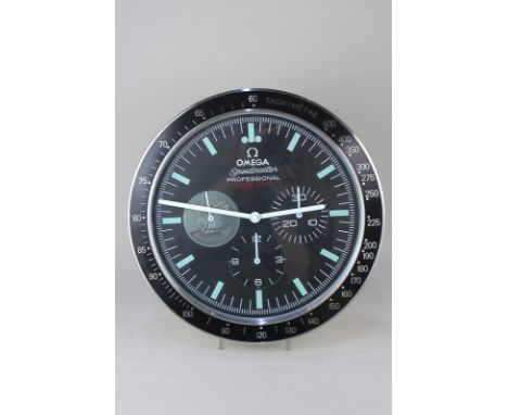 An Omega advertising wall clock, Speedmaster Professional, with three ornamental subsidiary dials, in black, 34cm