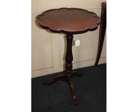 A mahogany wine table with circular scroll carved top, on baluster stem and tripod base, 48cm