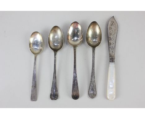 A George III silver Old English pattern dessert spoon with bright cut handle, London 1801, three other silver dessert spoons,