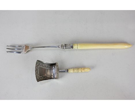 A George III silver caddy spoon, trowel form with engraved border, maker William Pugh, Birmingham 1809, and a later silver pi
