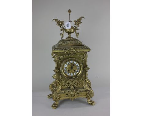 A Louis XVI style gilt metal mantle clock with four inch dial, cartouche shaped enamel Roman numerals, bell striking movement