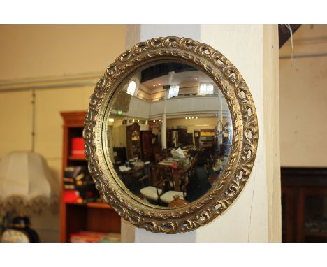 A circular convex wall mirror with pierced gilt frame, mirror plate 24cm diameter