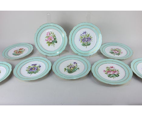 A set of nine porcelain dessert plates painted with floral sprays on white ground surrounded by a blue and gilt border, with 