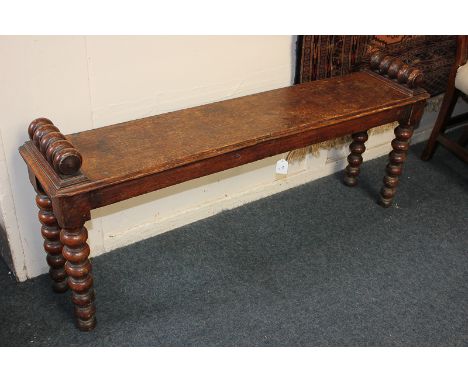 An oak bench with bobbin turned end blocks and matching turned legs, 121cm