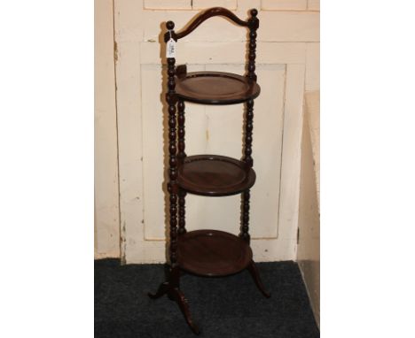 A mahogany three-tier folding cake stand on bobbin turned supports, 94cm high