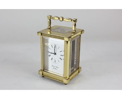A gilt brass cased carriage clock, the dial and movement marked Lionel Peck, London, with Roman numerals and key wind movemen
