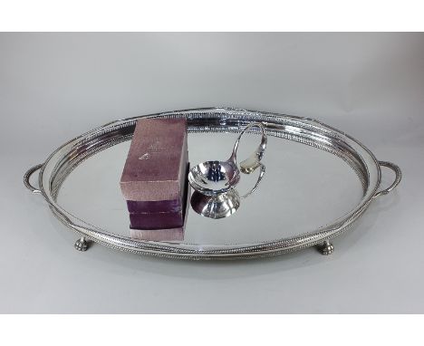 A Sheffield silver plated ladle in Asprey box, together with a large oval silver plated tea tray with pierced gallery and two