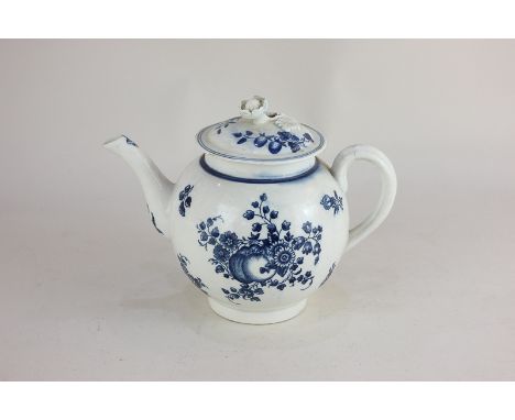 An 18th century Caughley blue and white porcelain teapot, the lid with flower shaped finial, decorated with cut fruit and flo