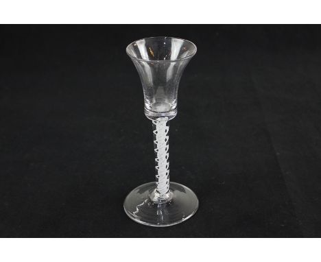 An 18th century wine / cordial glass with waisted bucket bowl and double twist stem on conical foot, rough pontil mark to bas