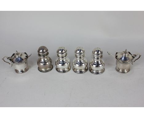 Four George V silver peppers, maker Alfred James How, London 1919, of baluster form, together with a pair of silver mustards,