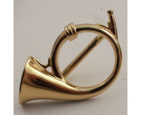 A Paris scarf ring, formed as a French horn, in gilt metal