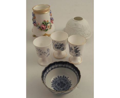 A 19th century Worcester vase, encrusted with floral swags, raised on three paw feet, dated 1876, height 5ins, together with 
