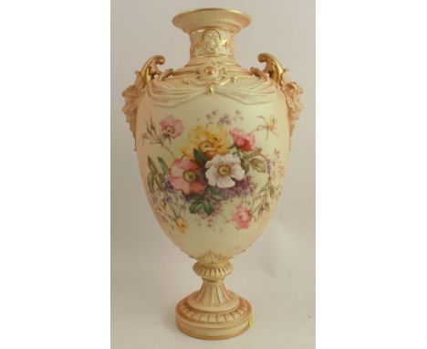 A Royal Worcester blush ivory vase, decorated with flowers, having well moulded mask handles, raised on a circular base, shap