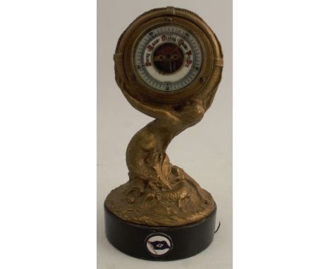 A maritime themed gilt brass aneroid barometer, raised on a wooden base, modelled as a mermaid surrounded by seaweed holding 