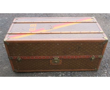Aux Etats Unis, Paris, a leather and wooden cabin trunk, with red and yellow band, initialled BB, the colours may possibly be