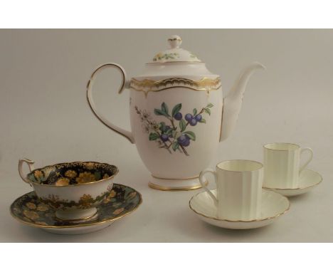 A Royal Worcester coffee pot, decorated with hazelnuts and sloes, height 8.5ins, together with a Wedgwood cup and saucer deco