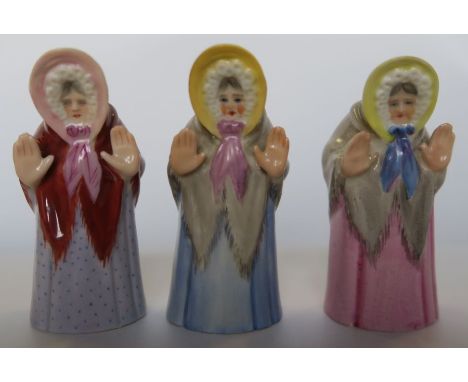Three Royal Worcester candle snuffers, modelled as Granny Snow, all in different colourways - Blue skirt cracked, other two o