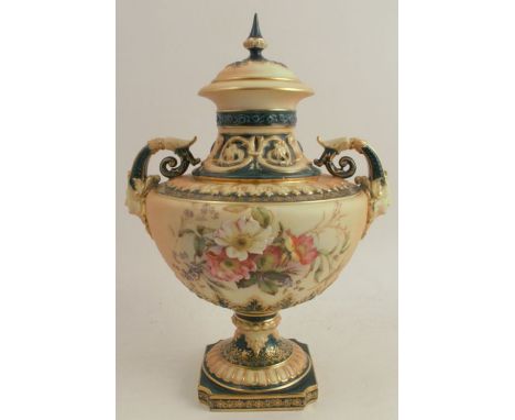 A Royal Worcester blush ivory and green covered vase, decorated with floral sprays, raised on a square pedestal foot, shape n