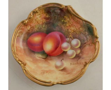 A Royal Worcester shaped dish, decorated with hand painted fruit to a mossy ground by Townsend, with scroll gilt border, sign