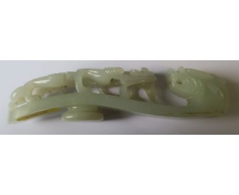 A Chinese jade belt buckle, in the form of a dragon looking at a walking lizard, length 6.25ins - two cracks