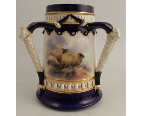 A Royal Worcester tapered three handled loving cup, decorated with a panels of sheep in winter, and sheep on a hillside, by H