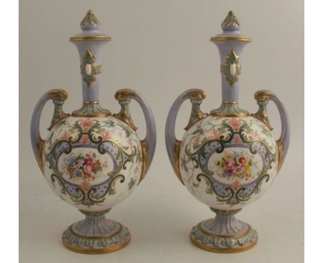 A pair of Royal Worcester covered vases, having trumpet necks and scroll handles, painted with sprays of flowers in foliate a