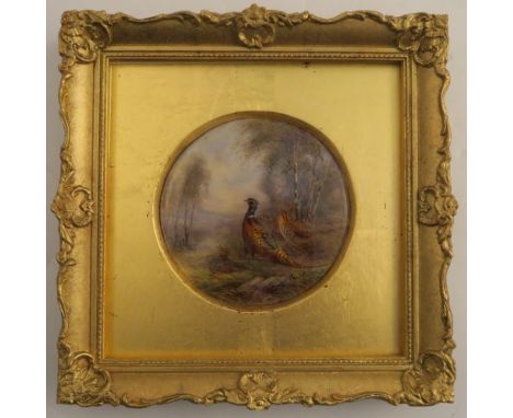 A circular Royal Worcester plaque, decorated with cock and hen pheasants in a wooded glade by James Stinton, circa 1921, diam
