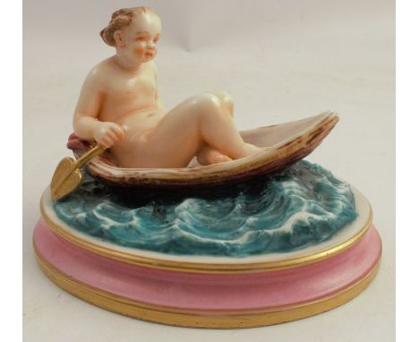 A Royal Worcester model, of a naked figure in a boat on water, on oval base, length 5ins - Some rubbing to gilding but otherw