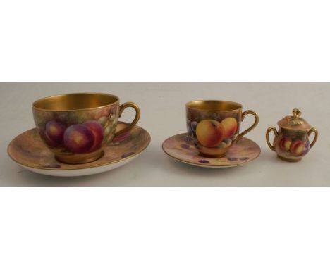 A Royal Worcester miniature cup and saucer decorated with fruit by Platt and Townsend - slight crack to the handle, together 