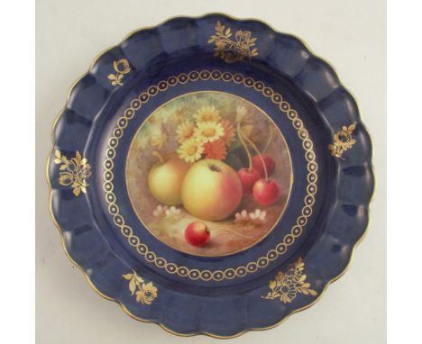 A Royal Worcester dish, of shaped circular form, the centre painted with fruit to a mossy background by A Shuck, diameter 7.7