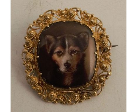 A porcelain panel brooch, of a terrier dog portrait to a cannetille mount - There are some chips to the edged of the enamelle