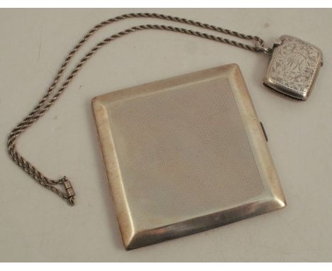 A hallmarked silver cigarette case, of square form with engine turned decoration, together with a hallmarked silver vesta cas