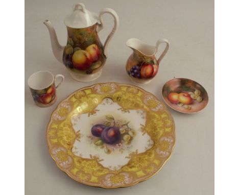A Royal Worcester plate, decorated with a fruit centre, to a yellow and gilt ground border, together with a small pin dish de