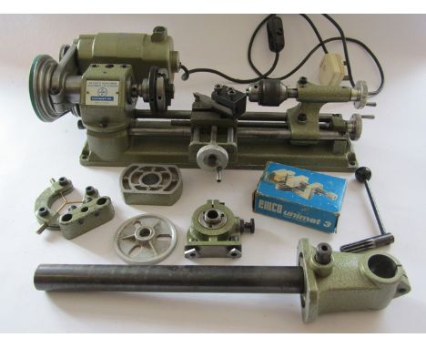 An Emco Unimat SL lathe with instructions, original boxes, various accessories inclding fixed steady, 3 and 4 jaw chucks, mac