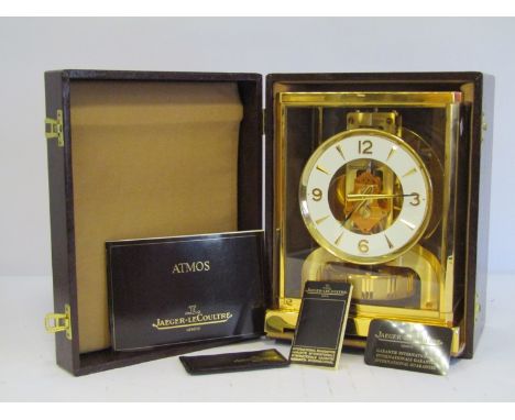 A Jaeger LeCoultre Atmos clock in gilt brass and glazed casing, serial no. 537523, with original boxes, manufacturer's and re