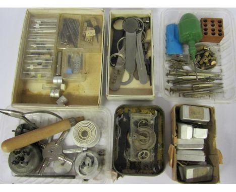 A box of mixed tools including movement holders, screwdrivers, spanners, balance stake, dust blower, watch bow rings etc