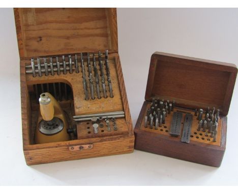 A cased staking set with assorted punches, stakes and mills (table damaged), together with a smaller box of stakes and punche