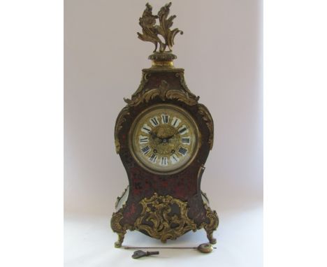 A 19th Century French ebonised and boulle work bracket clock of waisted form, gilded dial with porcelain Roman cartouche chap