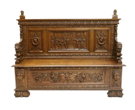 A Victorian Carved-Oak Hall Bench, late 19th century, the back support with stiff-leaf-carved border above four moulded panel