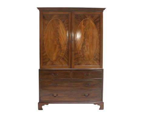 A George III Mahogany and Tulipwood-Banded Linen Press, late 18th century, the moulded cornice above two cupboard doors with 