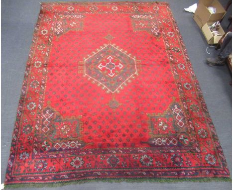 Turkish Ushak or Oushak rug in red, black, olive greens and pale blue, the central six sided lozenge with star motif, 386 x 3