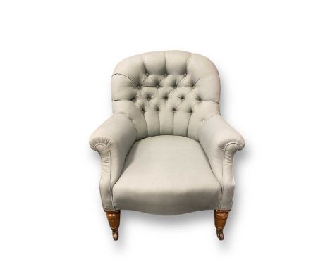 An Edwardian mahogany button back armchair with turned front legs and splayed back legs on ceramic castors, stamped Cope's pa